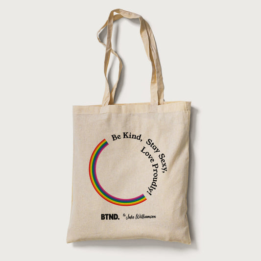 Beige tote bag with rainbow design and text on a white background